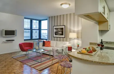 a living room with a couch and a table at Furnished Quarters at Grove Pointe in Jersey City