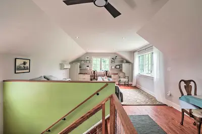a living room with a ceiling fan and a staircase at Barn-Like Studio Suite with Flowering Garden! in Titusville
