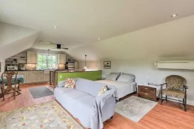 a living room with a bed and a couch at Barn-Like Studio Suite with Flowering Garden! in Titusville
