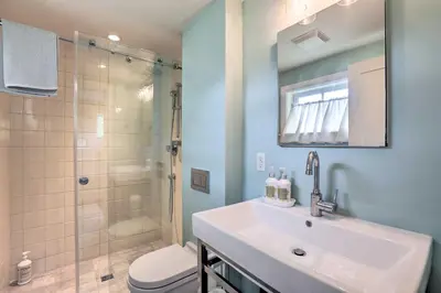 a bathroom with a sink and a shower at Barn-Like Studio Suite with Flowering Garden! in Titusville