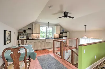 a kitchen with a table and a ceiling fan at Barn-Like Studio Suite with Flowering Garden! in Titusville