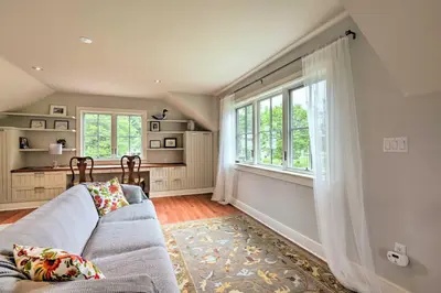 a living room with a couch and a window at Barn-Like Studio Suite with Flowering Garden! in Titusville