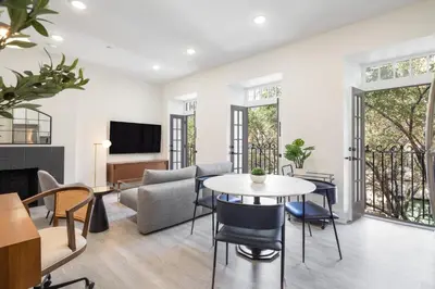a living room with a table and chairs at Sosuite at French Quarters - Rittenhouse Square in Philadelphia