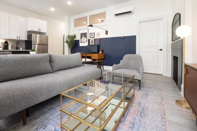 a living room with a couch and a glass coffee table at Sosuite at French Quarters - Rittenhouse Square in Philadelphia
