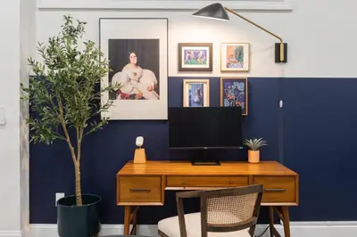 a desk with a television and a potted plant at Sosuite at French Quarters - Rittenhouse Square in Philadelphia