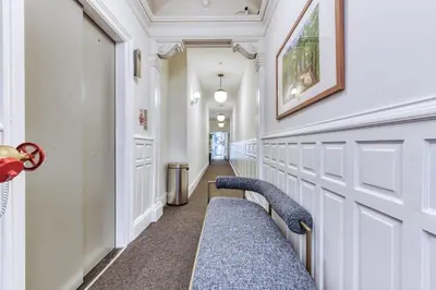 a hallway with a blue bench in a building at Sosuite at French Quarters - Rittenhouse Square in Philadelphia