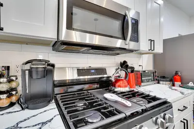 a kitchen with a stove and a microwave at about 4 Mi to Downtown Philadelphia Cozy Retreat in Philadelphia
