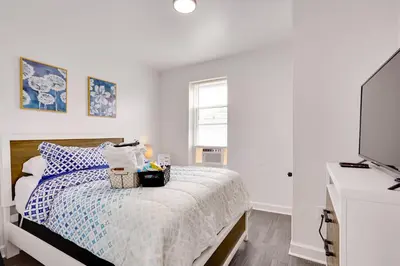 a bedroom with a bed and a flat screen tv at about 4 Mi to Downtown Philadelphia Cozy Retreat in Philadelphia
