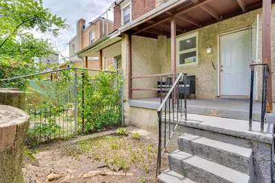 a house with a gate and stairs in front of it at about 4 Mi to Downtown Philadelphia Cozy Retreat in Philadelphia