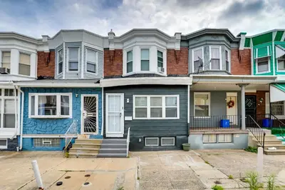 a row of houses with blue paint at about 4 Mi to Downtown Philadelphia Cozy Retreat in Philadelphia