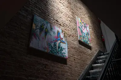 a brick wall with three paintings on it at The Flat NYC in New York