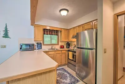 a kitchen with wooden cabinets and a stainless steel refrigerator at Deck and Resort Amenities Pocono Lake Home in Pocono Lake