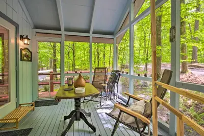 a screened in porch with a table and chairs at Deck and Resort Amenities Pocono Lake Home in Pocono Lake