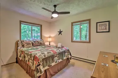 a bedroom with a bed and a ceiling fan at Deck and Resort Amenities Pocono Lake Home in Pocono Lake