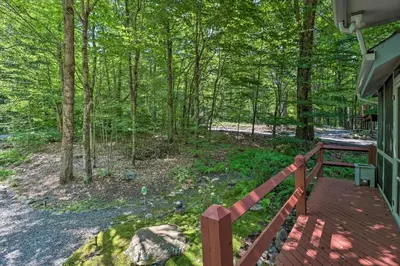 a porch of a house with a wooden fence at Deck and Resort Amenities Pocono Lake Home in Pocono Lake