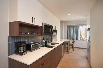 a kitchen with a counter top with a microwave at Staybridge Suites Wilmington Downtown by IHG in Wilmington