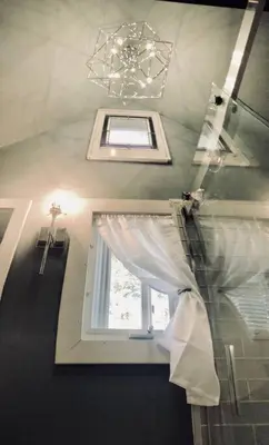 a room with a window and a chandelier at Bear Cottage in Birchwood Lakes