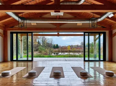 a yoga class in a room with large windows at Wildflower Farms, Auberge Collection in Gardiner