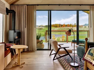 a living room with a view of a balcony at Wildflower Farms, Auberge Collection in Gardiner