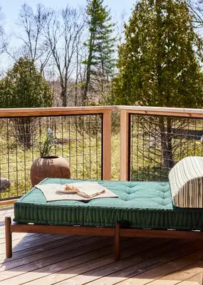 a wooden bench sitting on a deck at Wildflower Farms, Auberge Collection in Gardiner