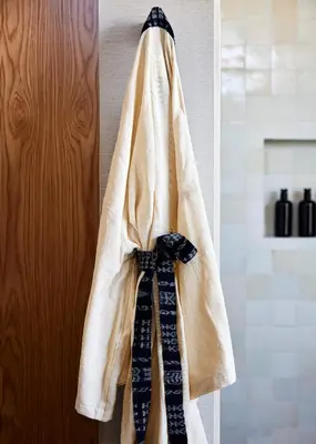 a robe hanging on a door with ties on it at Wildflower Farms, Auberge Collection in Gardiner