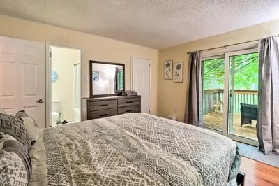 a bedroom with a bed and a view of a deck at 7 Mi to Lake Harmony Home with Furnished Deck! in Albrightsville