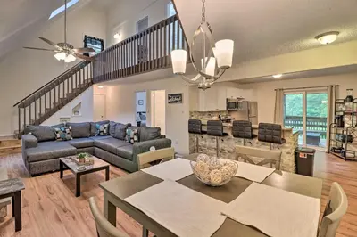a living room with a couch and a table at 7 Mi to Lake Harmony Home with Furnished Deck! in Albrightsville