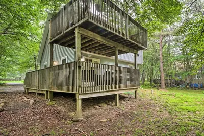 a house with a large balcony on top of it at 7 Mi to Lake Harmony Home with Furnished Deck! in Albrightsville