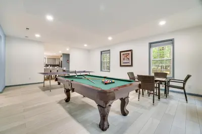 a living room with a pool table and chairs at Game Room and Home Theater! Immaculate Poconos Lodge in Albrightsville
