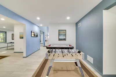 a pool table in a room with blue walls at Game Room and Home Theater! Immaculate Poconos Lodge in Albrightsville