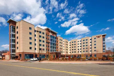 a large apartment building on the side of a street at Residence Inn by Marriott Secaucus Meadowlands in Secaucus