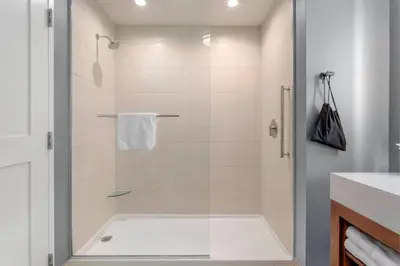 a bathroom with a shower with a tub at Residence Inn by Marriott Secaucus Meadowlands in Secaucus