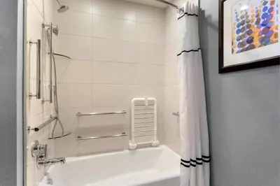a bathroom with a bath tub with a shower curtain at Residence Inn by Marriott Secaucus Meadowlands in Secaucus