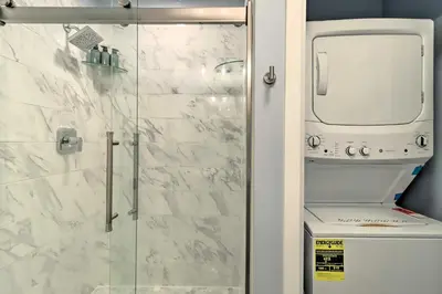 a bathroom with a glass shower stall and a toilet at Near Skiing and Hiking Gouldsboro Home with Hot Tub in Gouldsboro