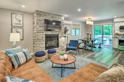 a living room with a couch and a fireplace at Near Skiing and Hiking Gouldsboro Home with Hot Tub in Gouldsboro