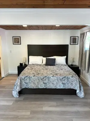a bedroom with a large bed and two night stands at New Hope Lodge in New Hope