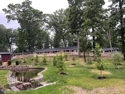 a garden with a pond in front of a building at New Hope Lodge in New Hope
