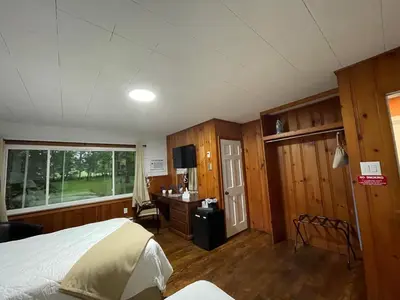 a bedroom with a bed and a desk and a window at New Hope Lodge in New Hope