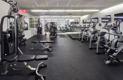 a gym with lots of treadmills and machines at Truss Hotel Times Square in New York