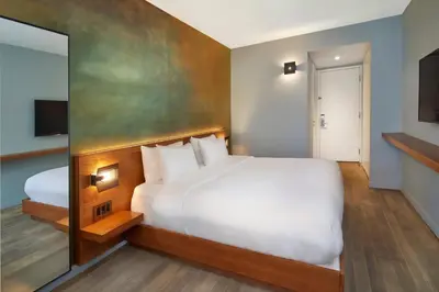 a hotel room with a large bed and a television at Truss Hotel Times Square in New York