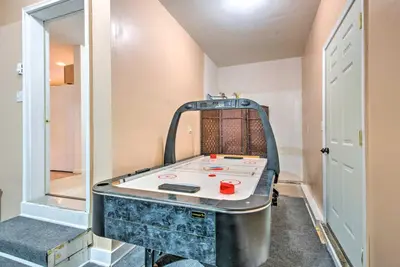 a room with a table in the middle of a room at Jacuzzi and Resort Amenities Tobyhanna Family Home! in Tobyhanna