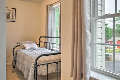 a bedroom with a bed next to a window at Jacuzzi and Resort Amenities Tobyhanna Family Home! in Tobyhanna