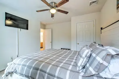 a bedroom with a bed and a ceiling fan at Jacuzzi and Resort Amenities Tobyhanna Family Home! in Tobyhanna