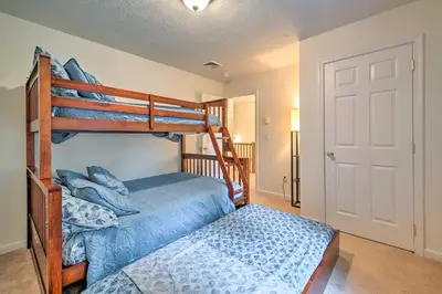 a bedroom with two bunk beds and a bed at Jacuzzi and Resort Amenities Tobyhanna Family Home! in Tobyhanna