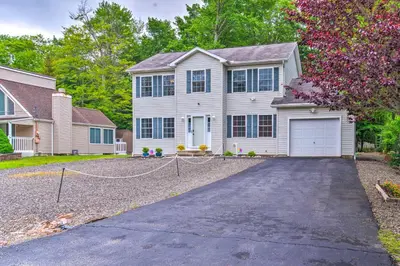 a large white house with a driveway at Jacuzzi and Resort Amenities Tobyhanna Family Home! in Tobyhanna