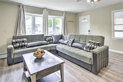 a living room with two couches and a table at Family-Friendly Keansburg Home Walk to Beach! in Keansburg
