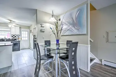 a dining room with a glass table and chairs at Family-Friendly Keansburg Home Walk to Beach! in Keansburg