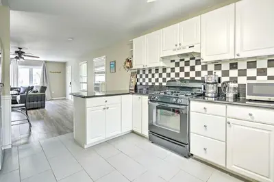 a kitchen with white cabinets and a stove top oven at Family-Friendly Keansburg Home Walk to Beach! in Keansburg