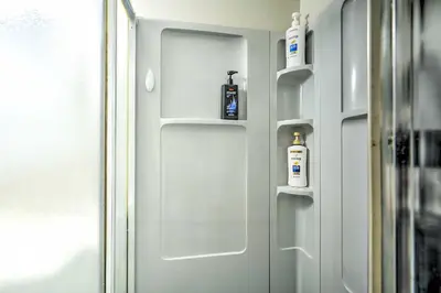 a door with two bottles ofodorizers sitting on it at Family-Friendly Keansburg Home Walk to Beach! in Keansburg