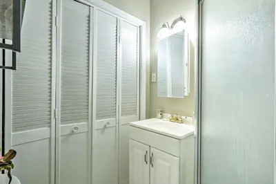 a white bathroom with a sink and a mirror at Family-Friendly Keansburg Home Walk to Beach! in Keansburg